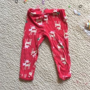 Red pants that have rain deer on them